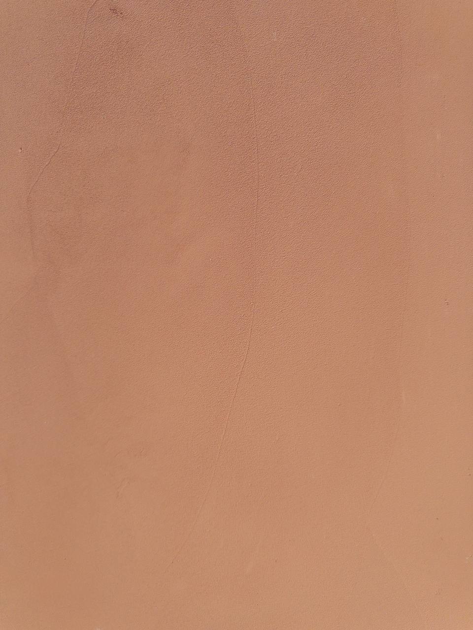#3 Terracotta Light Romanus clay plaster on a wall, close-up of the matte texture