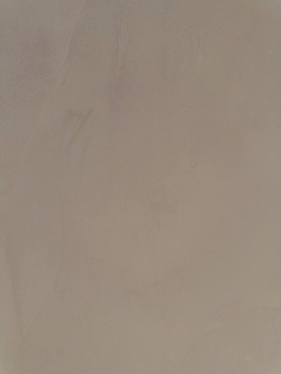 #8 Clay Taupe Romanus clay plaster on a wall, close-up of the matte texture