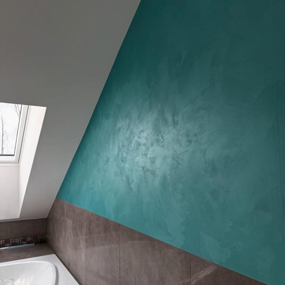 Velvetus decorative silk stucco in teal on a bathroom wall under a sloping ceiling