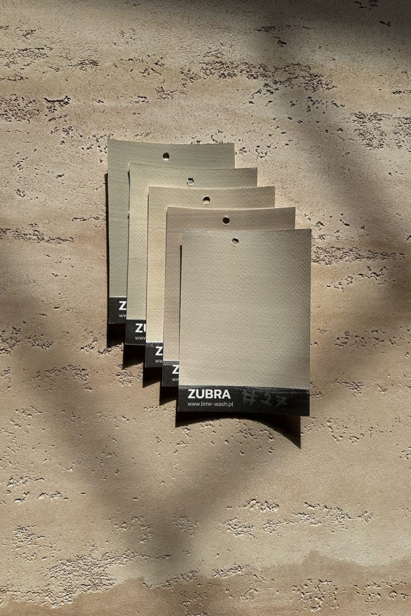 Earthy-toned limewash Colour Cards on a textured stone wall
